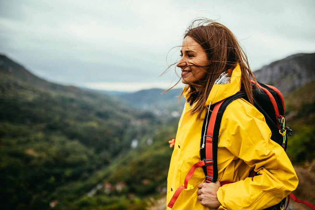 woman standing on a mountain top hike