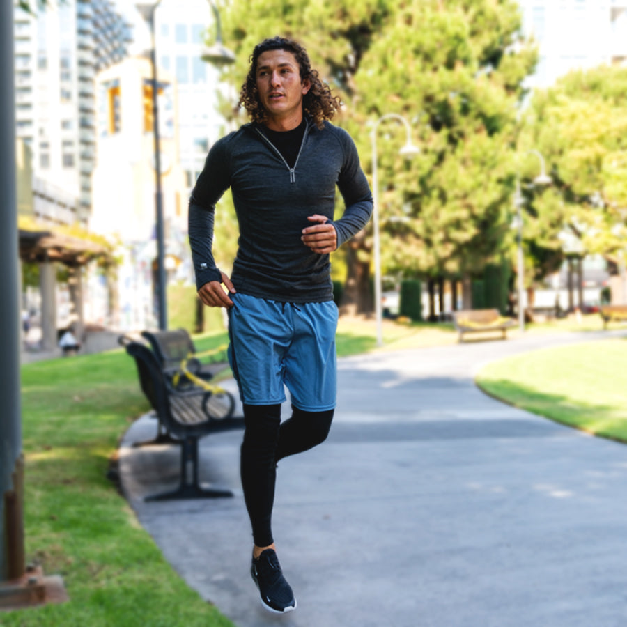 Man running outside wearing merino wool thermal underwear in a park