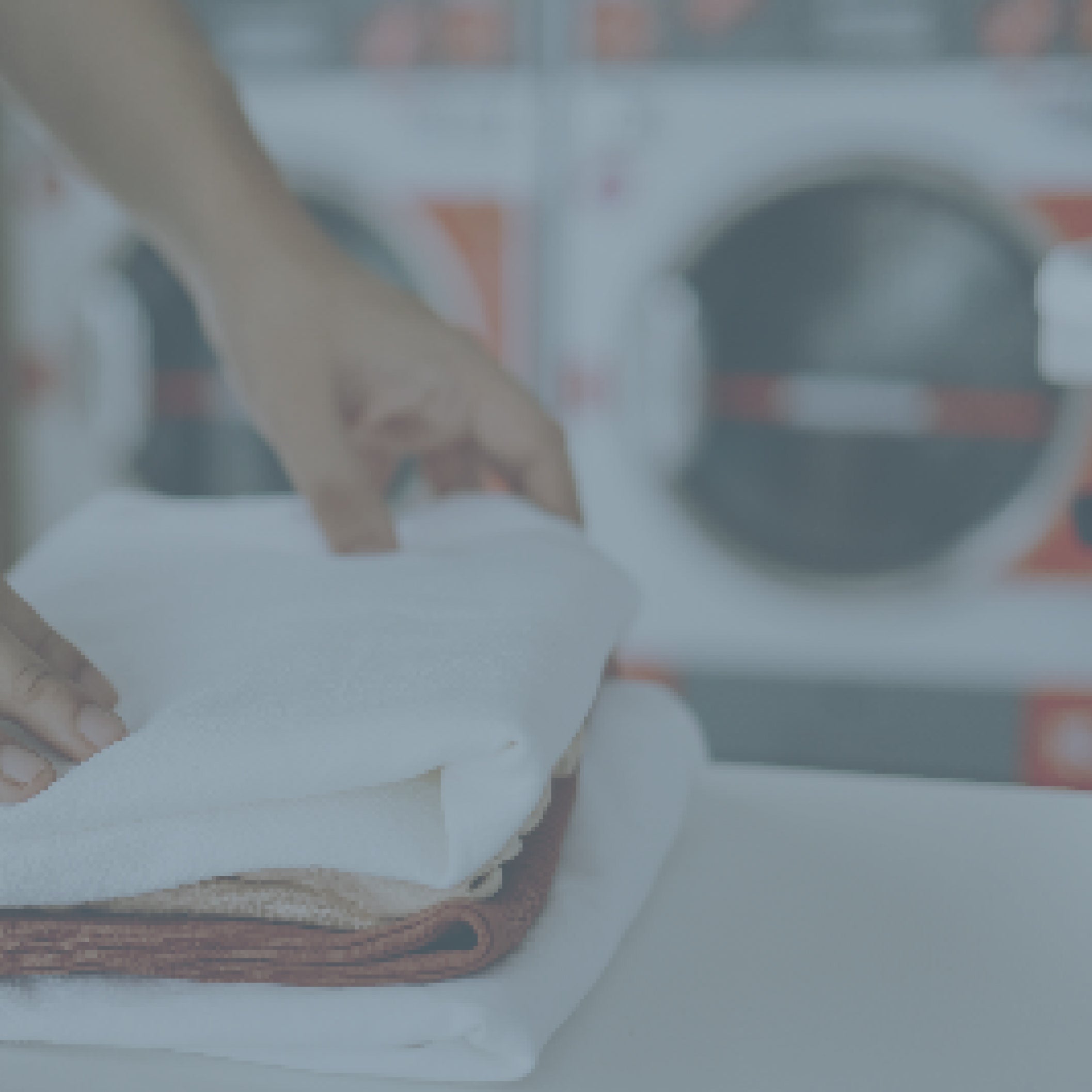 Person folding laundry in a laundry mat