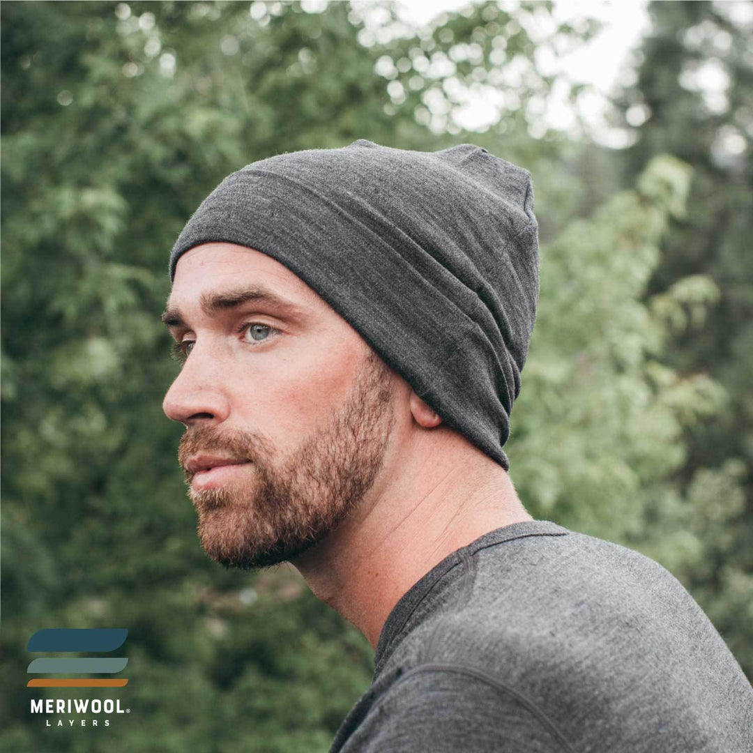 man outside wearing a charcoal gray merino wool 250 cuffed beanie